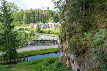 Fototapeta na wymiar Ligatne, Latvia - 07.18.2023: View on abandoned Anfabrika or Handfabrika paper mill and Anfabrika Cliffs in Ligatne, Latvia