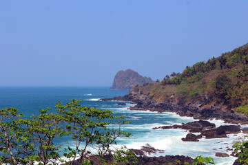 Beautiful seascape with waves against rocks. High angle view of a beach in Trenggalek, East Java, Indonesia.