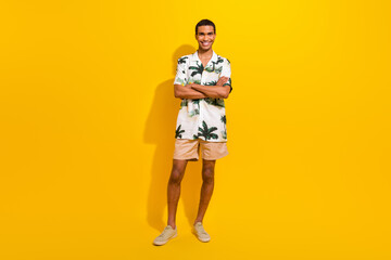 Fototapeta na wymiar Full body photo of attractive young man folded arms confident dressed stylish palms print clothes isolated on yellow color background