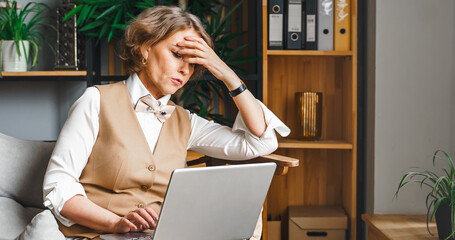 Stress, anxiety, problems. Tired thinking confident mature middle aged elderly businesswoman...