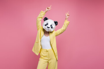 Photo of positive carefree woman dressed blazer suit panda mask pointing two fingers up empty space...