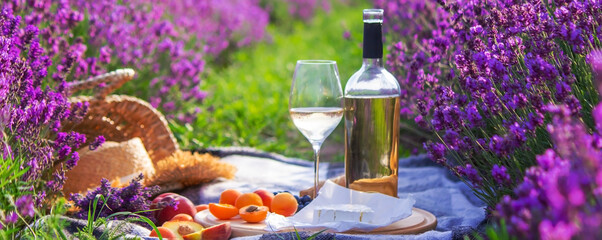 wine, fruits, berries, cheese, glasses picnic in lavender field Selective focus © Anna