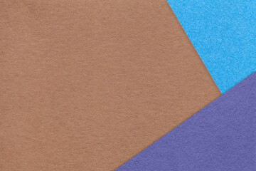Fototapeta premium Texture of craft brown color paper background with blue and violet border. Vintage abstract cardboard.