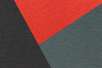 Texture of craft black, red and teal shade color paper background, macro. Vintage abstract cardboard