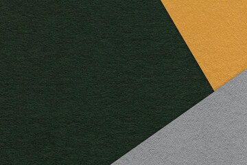 Texture of craft dark green color paper background with yellow and gray border. Vintage abstract...