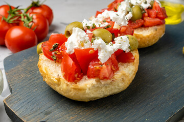 Greek dish close-up Dax, juicy tomatoes with olive oil and feta cheese.