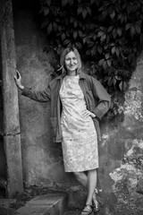 Full-length portrait of a woman on the street. Black and white photo.