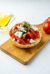 Close-up of Greek dish dakos on a wooden board,light table.