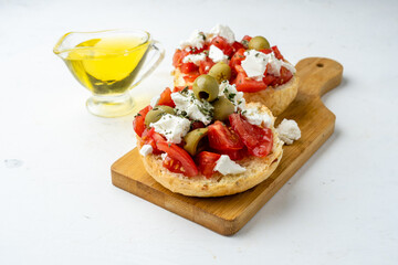 Greek dish dakos close-up against a light background.