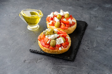Dakos Greek cuisine on a dark background.
