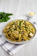 Homemade Creamy Chicken Bacon Pesto Pasta on a Plate, side view.