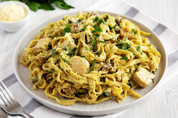 Homemade Creamy Chicken Bacon Pesto Pasta on a Plate, side view.