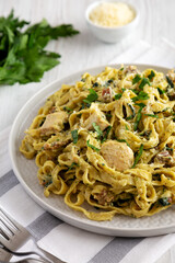 Homemade Creamy Chicken Bacon Pesto Pasta on a Plate, side view.