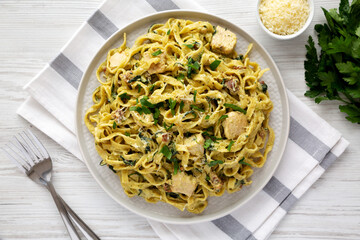 Homemade Creamy Chicken Bacon Pesto Pasta on a Plate, top view. Flat lay, overhead, from above.