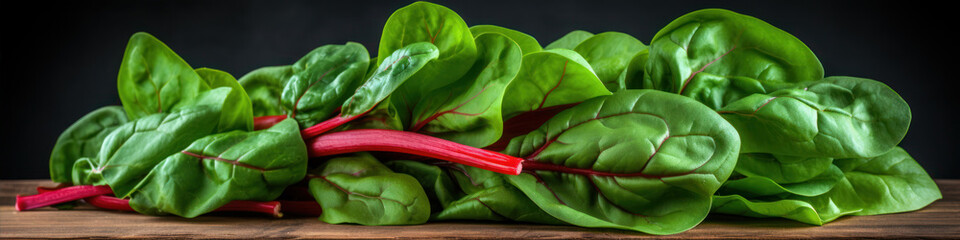 Fresh spinach leaves on wooden board over black background. Healthy food concept. - obrazy, fototapety, plakaty