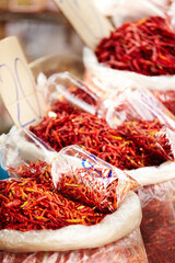 Chilli, pepper and market for shopping sale, discount or wholesale promotion at vendor store or local trading. Bag of dried fruits, red vegetables and spice for food and flavor with empty background