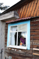 Window in an old wooden house view from the street