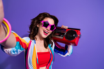 Portrait of excited lady hold boom box make selfie recording video for internet blogging isolated vivid color background