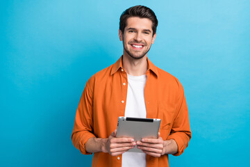 Photo of cheerful cute man dressed orange shirt communicating instagram twitter telegram facebook...