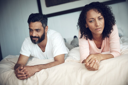 Divorce, conflict and couple in bedroom for problem, frustrated and marriage fail with mental health risk. Thinking, fighting and woman with man, home and relationship issue with anxiety and stress