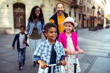Young blended stepfamily having a stroll downtown in the city