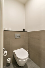 a toilet in the corner of a bathroom with tile on the floor and walls, it's all white