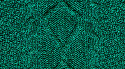 Macro green handmade woolen sweater fabric texture. Close up