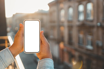 Phone in hands with isolated screen on the background of ancient buildings - obrazy, fototapety, plakaty
