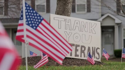 Close up of Slow waving many American flags blowing in the wind on a cloudy day. Patriotic concept for US holidays, Veteran's day. Close up shot