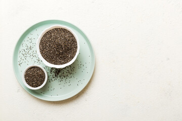 Chia seeds in bowl on colored background. Healthy Salvia hispanica in small bowl. Healthy superfood