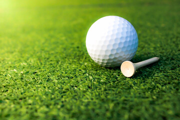 Golf balls and tees placed on the grass.