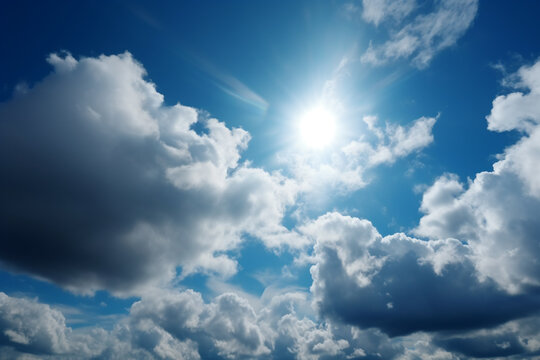 Blue sky background with tiny clouds and sun. Natural sky background.