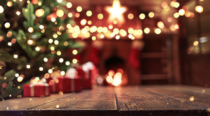Christmas background. Wooden background closeup with blurred Christmas tree and gifts against the backdrop of the fireplace and holiday lights - obrazy, fototapety, plakaty