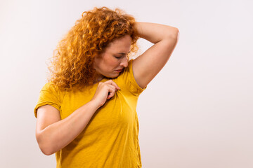 Ginger woman is sweating to much and she doesn't like her smell under armpit.