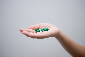 woman holding pills in hand preparing for use The concept of taking care of one’s health and helping people in the house,shotlisthealth