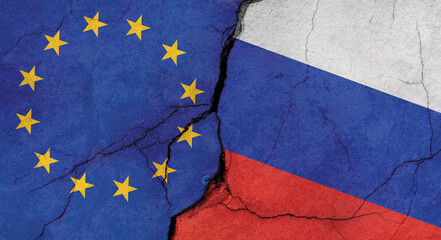 EU and Russian flags, concrete wall texture with cracks, grunge background, military conflict concept