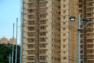 Fototapeta na wymiar Close-up of the constructing building in Hong Kong street. Construction scene, cityscape.