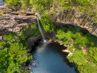 Aerial view of the scenic waterfall Chorro San Luis embedded in a thick, tropical forest near...