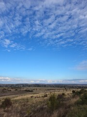 A landscape with a blue sky and clouds