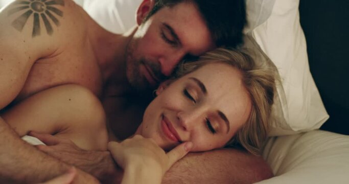 Home, cuddle and couple with love, smile and relax with intimacy, bonding together and romance. Romantic, man and woman in the bedroom, calm and marriage with relationship, happiness and honeymoon