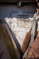 A fragment of a barn wall with a small window