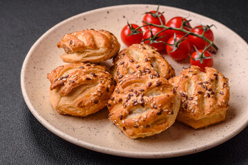 Delicious crispy mini puffs with sausage or meat with salt, thyme and sesame
