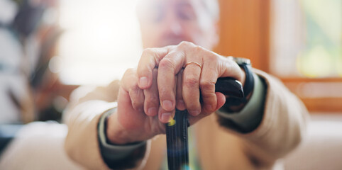 Walking stick, hands and senior man with a disability in home, apartment or retirement with support for injury. Elderly, closeup or person with wood cane to help balance or mobility with arthritis