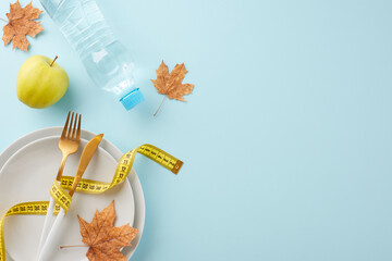 Autumnal weight loss and toning. Top view photo of plates, cutlery, water bottle, tape measure,...