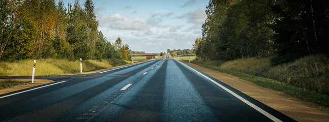 Riga - Valmiera asphalted new road. Road traffic on Latvian roads. Road with asphalt coating. Heavy...