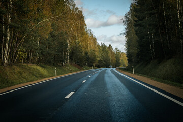 Riga - Valmiera asphalted new road. Road traffic on Latvian roads. Road with asphalt coating. Heavy and light vehicle movement.