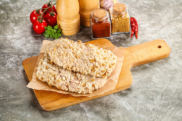 Breaded raw breaded meat schnitzel