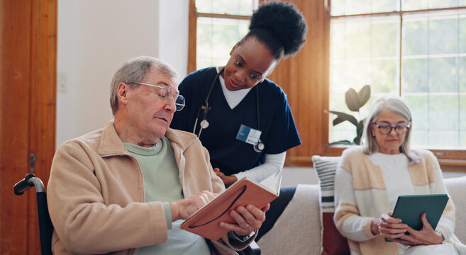 Senior Man, Reading And Nurse Talking In Home With Book, Discussion Or Support From Nursing Staff. Retirement, Elderly Care Or Person Relax In Conversation With Caregiver In Living Room With Notebook