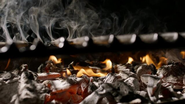 fanning barbecue grill grate ready to cooking steaks, meat or vegetables, Empty hot barbecue grill with a flame of fire on black background hot summer party concept copy space 
