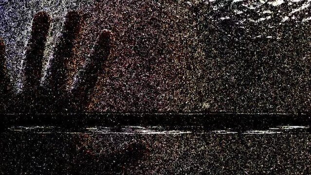 Silhouette of a men's hand on glass scratching and static tv noise, scary movie tv screen noise
